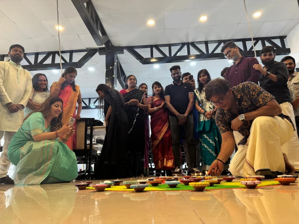 Team celebrating Diwali with traditional lamps in the office