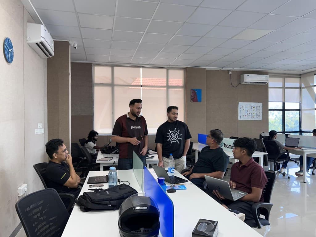 Colleagues collaborating around desks in the open-plan office